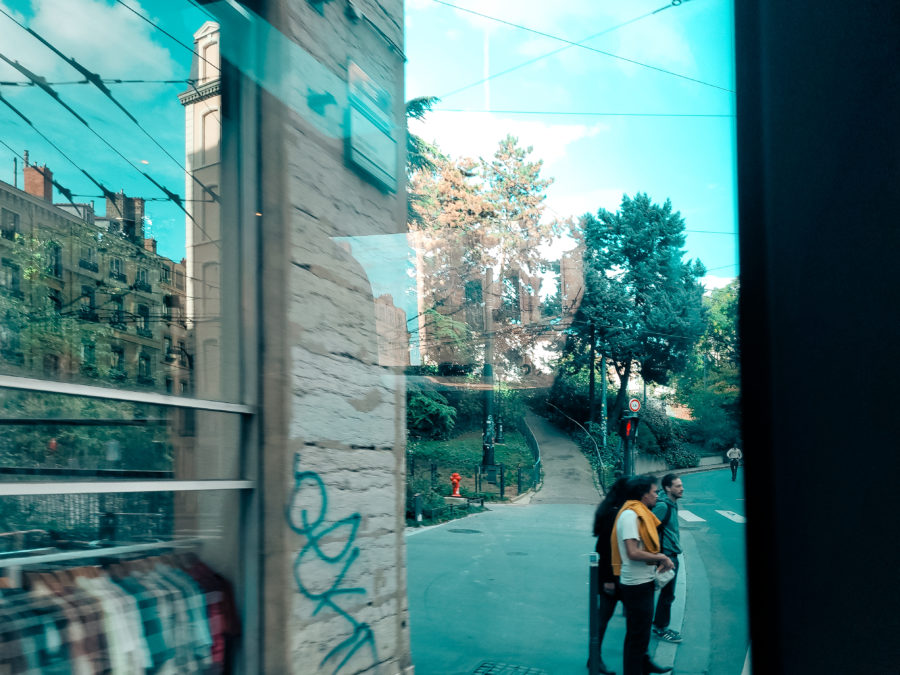 Scène de rue à Lyon, photographiée depuis le tramway, tons bleus, fujifilm xs10, photo prise par Barbara Ferreres, octobre 2024